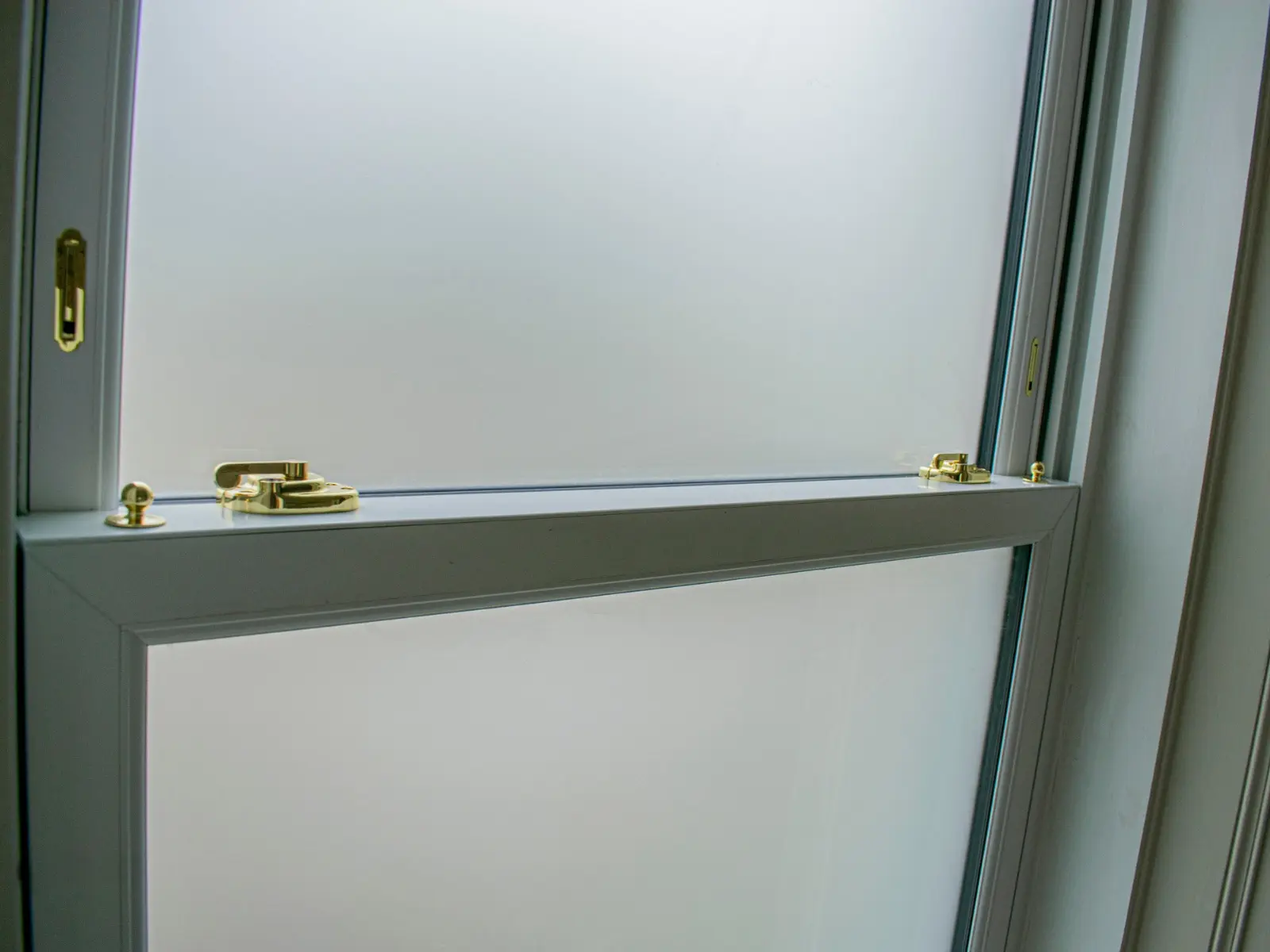 White uPVC sliding sash window installation, Dundee